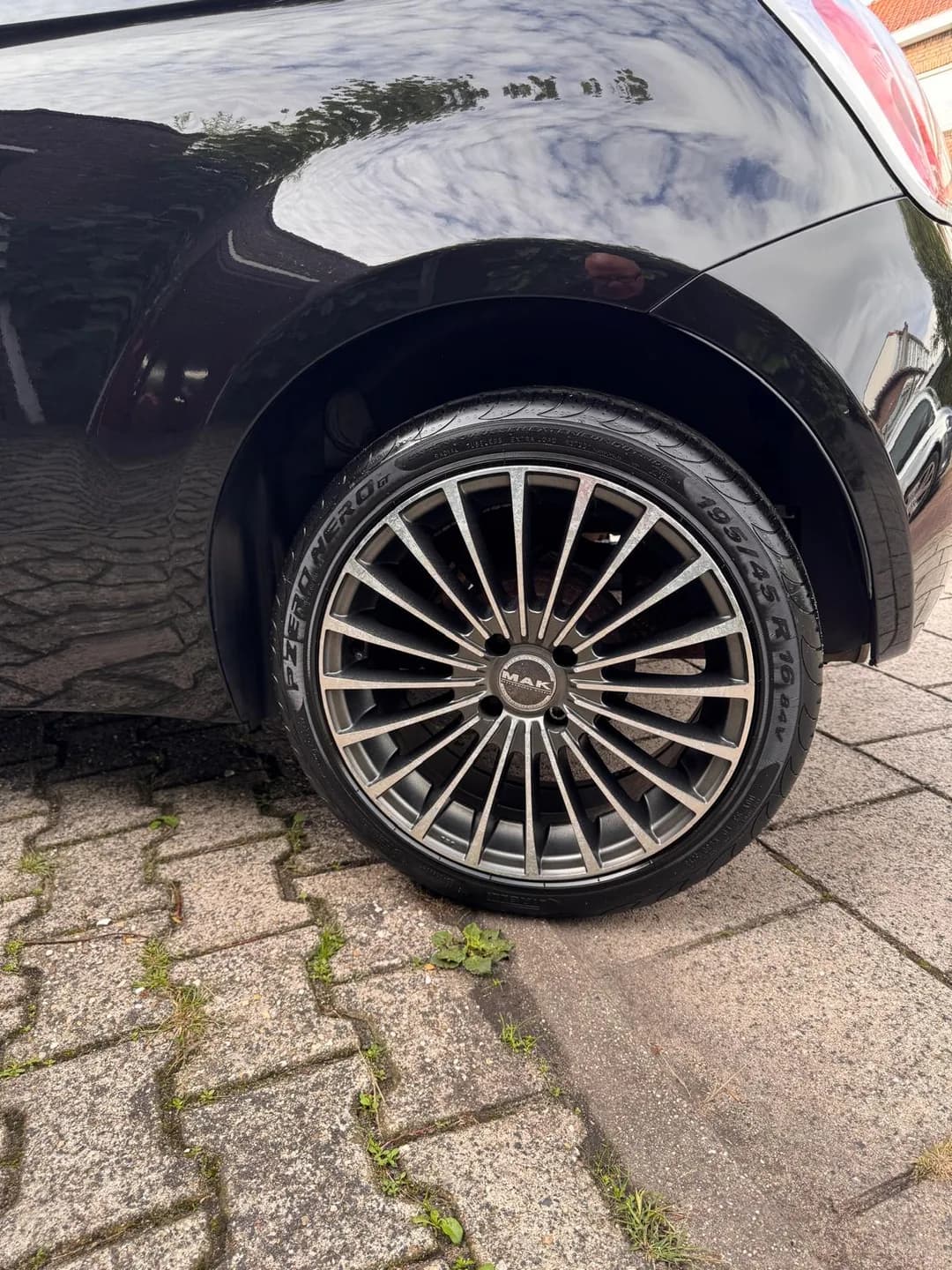 Meerspaaks velg en achterste wielkast van de zwarte Fiat 500